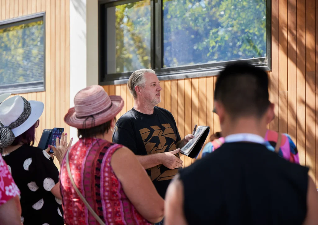 Artist MERDA speaks with a guided tour group at the 2024 Benalla Street Art Festival Photo by Holly Hawkins