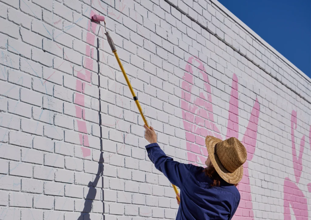 Neryl Walker paints her work as part of the 2024 Benalla Street Art Festival Photo by Holly Hawkins