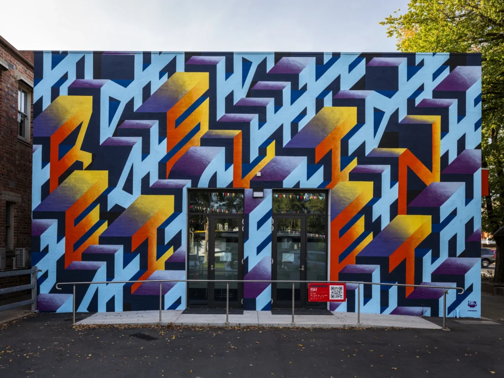 This artwork celebrates the resilience of country towns like Benalla. HWJ uses the word 'Resilient' to symbolize the strength needed to sustain rural communities. The colours reflect the stunning sunrises and sunsets often seen in the area. This artwork was part of the 2025 Benalla Street Art Festival.