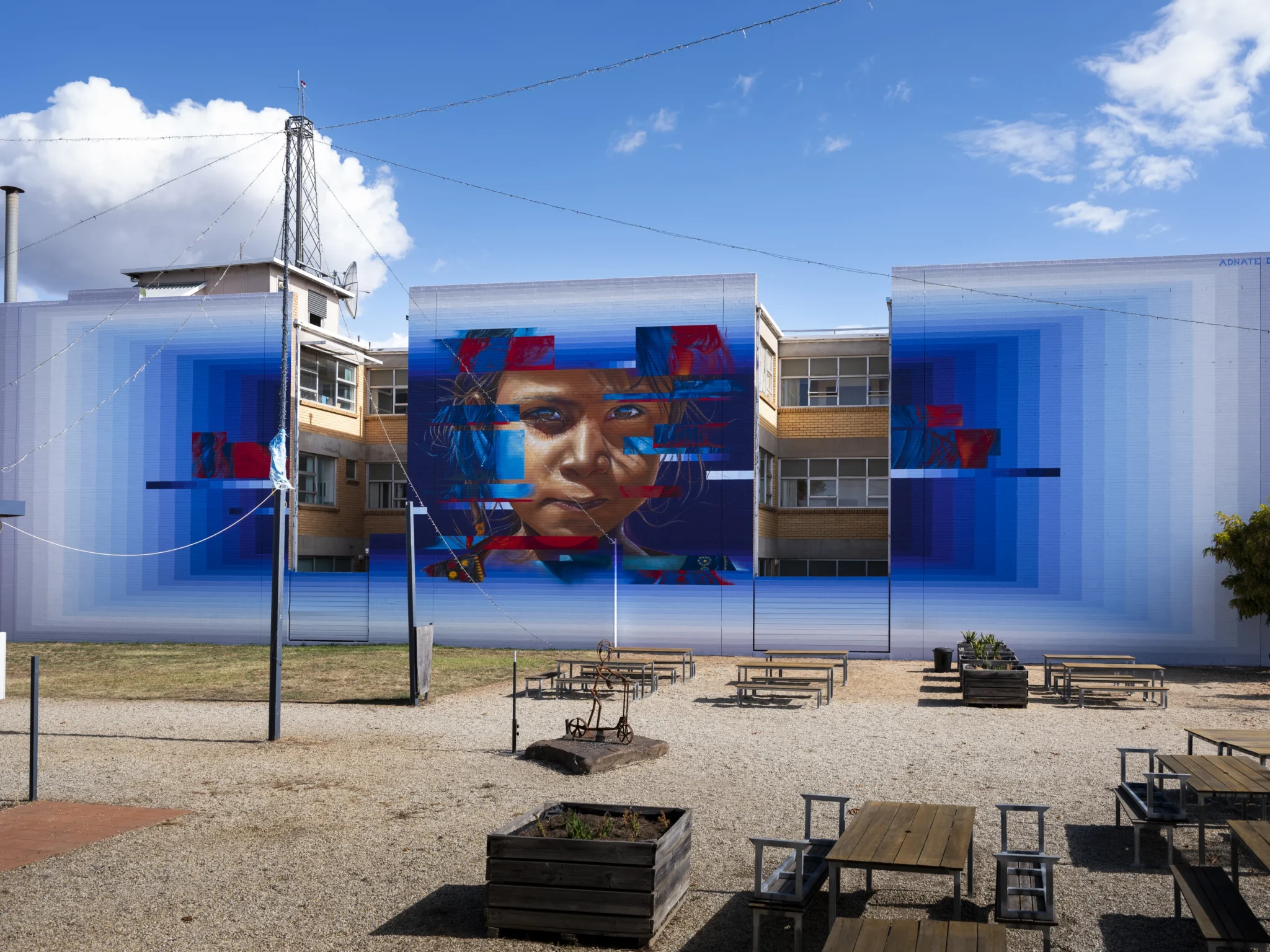 Blending his signature high-density detail with modern techniques that reflect a decade of artistic growth. It’s both a tribute and a bold evolution. This artwork was part of the 2025 Benalla Street Art Festival.