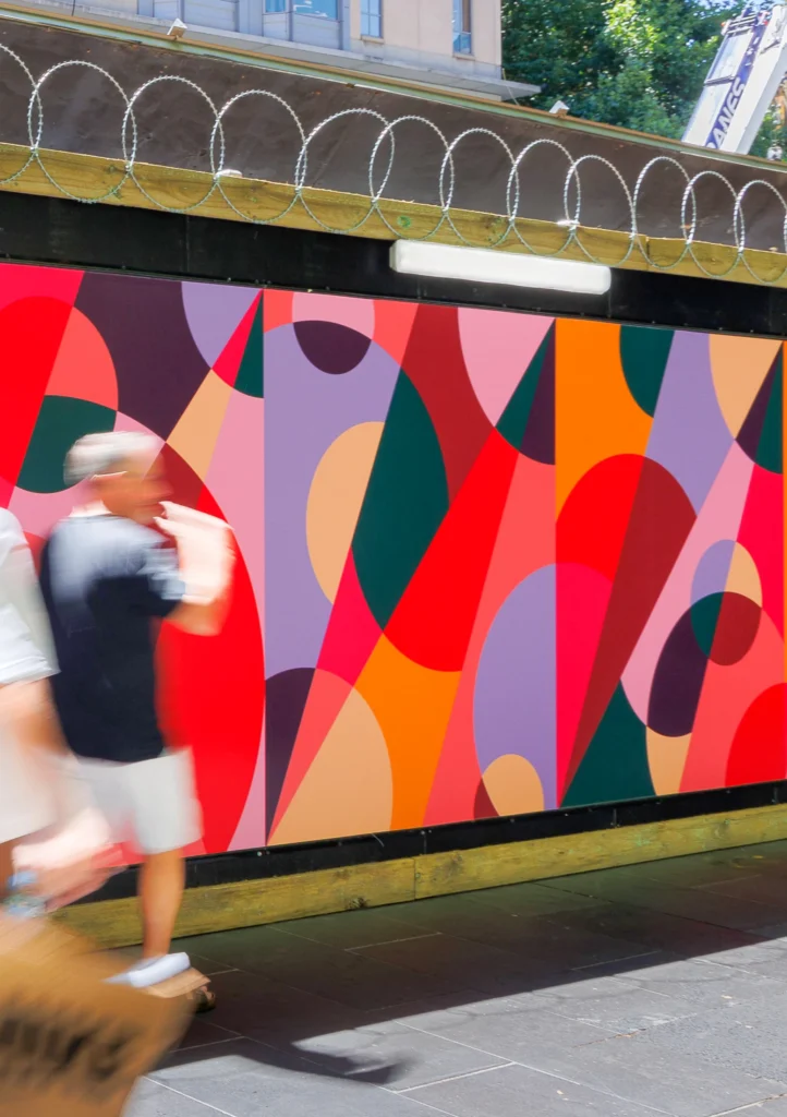 People passing by artwork by Spencer Harrison