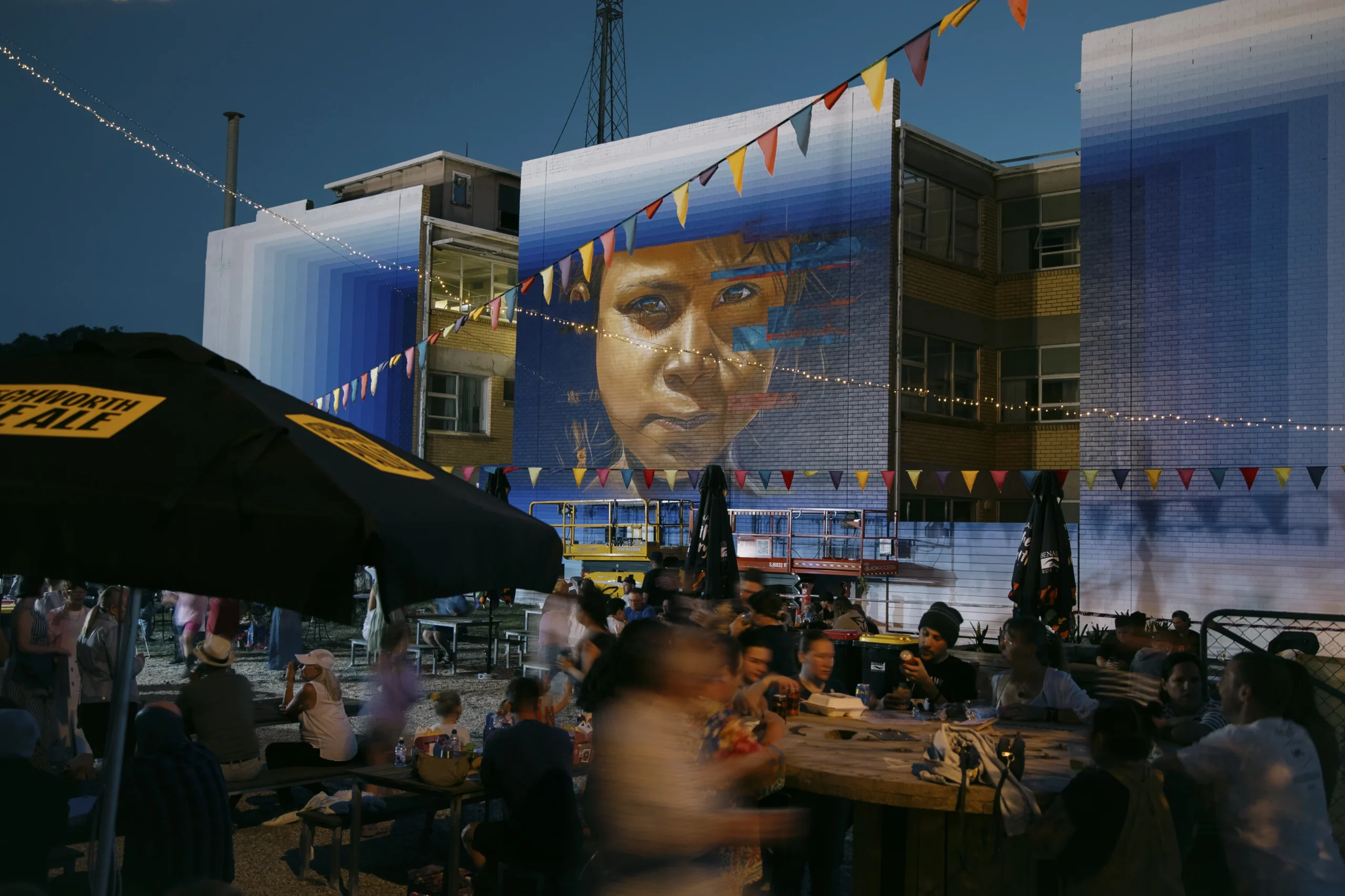 The Hub at the Benalla Street Art Festival 2025 buzzing with activity as Adnate and DREZ collaborate on an epic artwork